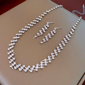 Detail view of the silver geometric jewelry set with tiered diamond-encrusted patterns