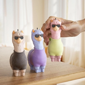 Three creative alpaca candles with sunglasses on a wooden surface in cozy home decor