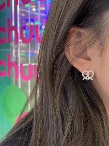 Close-up of S925 sterling silver pretzel knot stud earring worn by a model