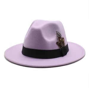 Detail of lavender fedora hat featuring a black ribbon and elegant feather accessory