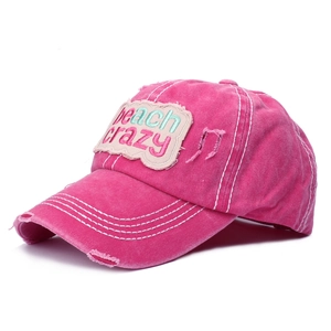 Macro side view of hot pink Beach Crazy patch baseball cap with distressed details