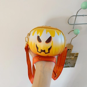 Detail of Halloween pumpkin crossbody bag with face print and striped strap