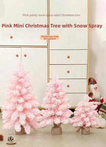 Three pink snow-flocked mini Christmas trees with burlap bases on a festive shelf