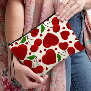 Portable cherry and heart pattern makeup bag with black wristlet strap and zipper