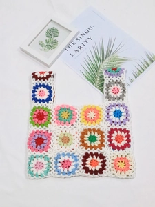 Detailed close-up of handmade crochet bag featuring colorful mixed floral patchwork patterns