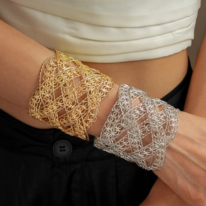 Detail of wide metallic mesh textured crossover cuff bracelet in gold and silver