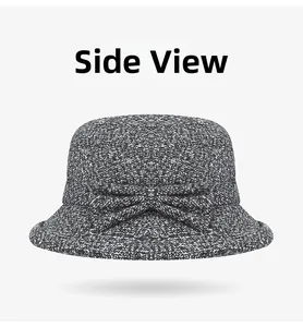 Side view of a warm black and white wool blend cloche hat with a decorative bow