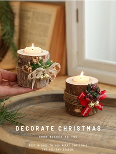 Detail of rustic wooden Christmas candle holders with berries and festive ribbons