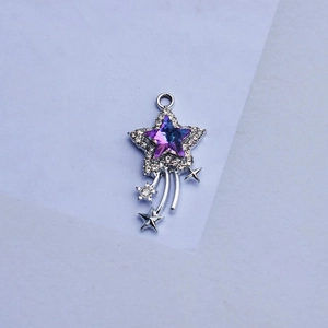 Close-up of shooting star pendant with purple-blue gradient stone and crystal border