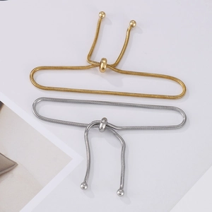 Detailed view of adjustable gold and silver snake chain bracelets with sliding bolos