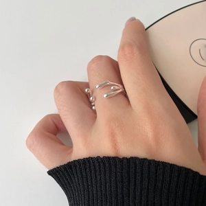 Close-up of irregular liquid metal style 925 sterling silver open ring on finger