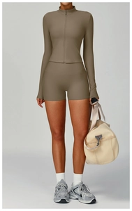 Detail of ribbed knit fabric on a slim fit high neck yoga jacket and sports shorts set