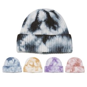 Detail showing ribbed knit beanies in various tie-dye colors including blue, purple, and pink
