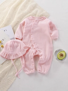 Pink cotton gauze baby romper set with long sleeves and matching ruffle sun hat