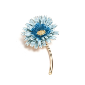 Detailed blue enamel sunflower brooch with golden accents on a clean white background