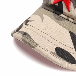 Close-up of camouflage tactical cap with a red embroidered star badge and neat stitching