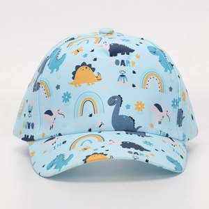 Detail of light blue cotton kids baseball cap featuring all-over cartoon dinosaur patterns