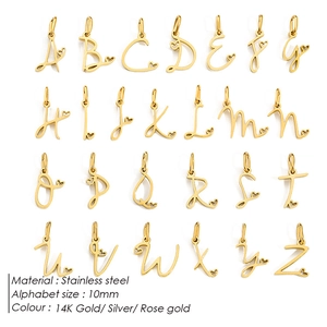 Macro view of 26 stainless steel cursive alphabet charms in a tidy grid layout