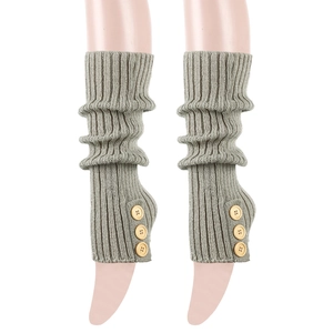 Detail of ribbed knit leg warmers in olive green with decorative wood buttons