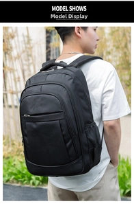 Outdoor shot of the large black nylon business backpack showing real-world capacity and fit