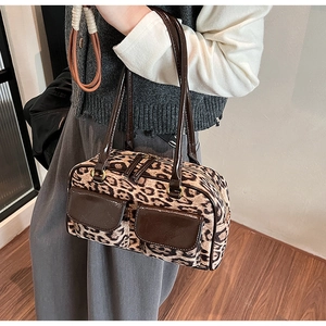 Detail view of leopard print texture and dark brown patent leather on a bowling bag