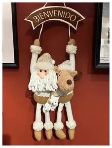 Christmas wall hanging featuring plush Santa and reindeer dolls with Bienvenido banner