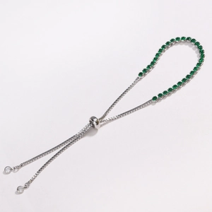 Detail of adjustable silver bolo bracelet with round green cubic zirconia stones