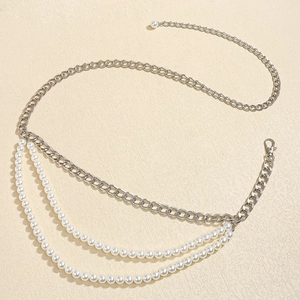 Detail view of multi-layered silver chain belt featuring white pearls and lobster clasp