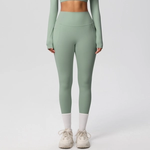 Detail of high-waisted sage green yoga set showing side pockets and brushed texture