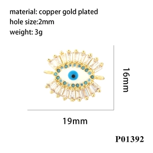 Macro view of 18K gold plated evil eye pendant with blue enamel and clear zircon details