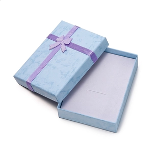 Light blue marble jewelry gift box with a purple ribbon bow and grey velvet lining