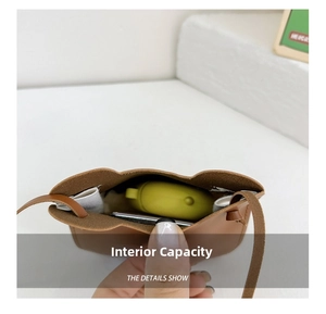 Detail showing internal storage space for earphones in brown leather mini bear bag