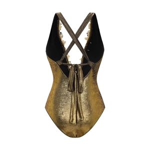 Detail of metallic gold one-piece swimsuit featuring crisscross back and floral lace embroidery