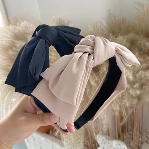 Elegant satin bow headband in black and champagne beige colors for a stylish look