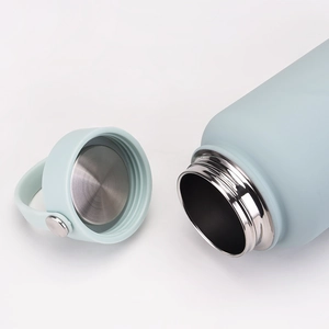Close-up of a 1L light blue matte insulated bottle showing stainless steel interior and lid