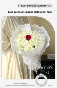Close-up of waterproof white lace floral wrapping film on a bouquet of white roses