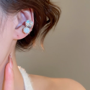 Close-up of minimalist ear cuff with two large round cubic zirconia on model's ear