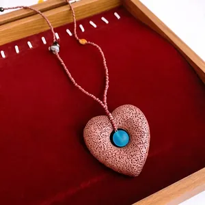 Retro heart pendant necklace with brown lava stone and blue bead on a fine beaded chain