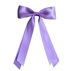 Detail of light purple satin bow hair clip with long ribbons and smooth silky texture