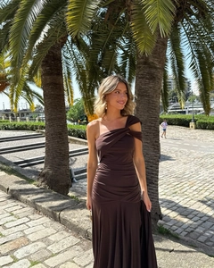 Detail of the elegant one shoulder ruched dress with side slit in dark brown fabric