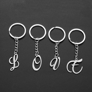 Polished stainless steel LOVE letter alphabet keychain set on dark background
