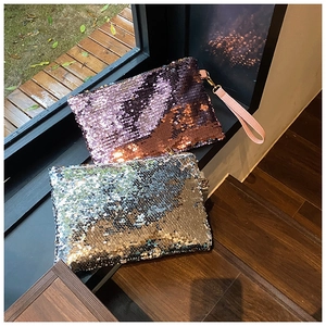 Close-up of sparkling lavender and silver sequin mini clutch bags with leather handles