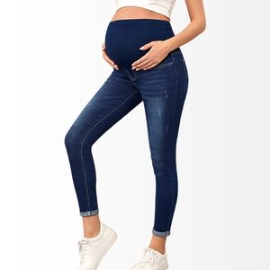 Detail of high-waisted maternity jeans with supportive belly band in dark blue denim