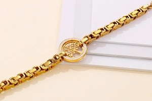 Macro shot of gold tree of life bracelet with sparkling crystals and metal chain