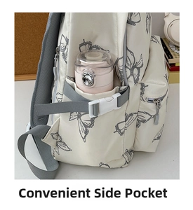 Detail view of the side pocket on a cream butterfly backpack with a pink water bottle