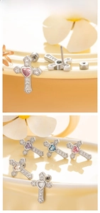Macro shot of titanium cross stud earrings with colorful heart zircon and pavé crystals