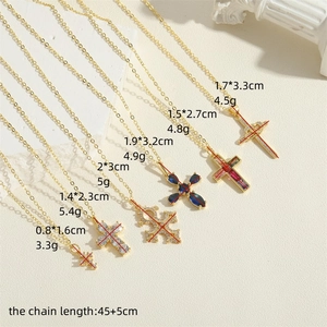 14K gold plated cross pendant necklaces with zircon crystals on an elegant background