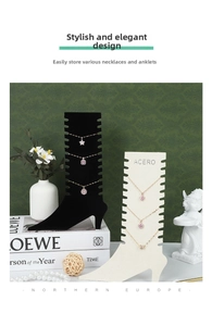 Detail of high heel jewelry stands with slots for necklaces in black and white finish