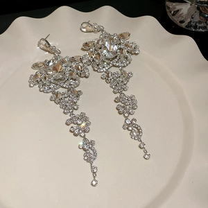 Detailed macro view of vintage silver tassel earrings with sparkling cubic zirconia crystals