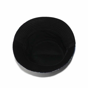 Inside view of a canvas sun hat featuring black interior lining and colorful sea patterns